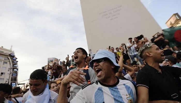 Fans of Argentina celebrate their team´s victory after the Qatar 2022 World Cup semifinal football match between Croatia and Argentina at the Obelisk in Buenos Aires on December 13, 2022. — AFP