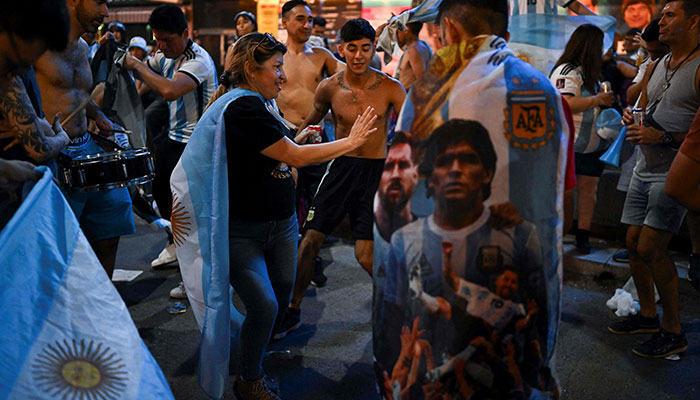 Fans of Argentina celebrate their team´s victory after the Qatar 2022 World Cup semifinal football match between Croatia and Argentina at the Obelisk in Buenos Aires on December 13, 2022. — AFP