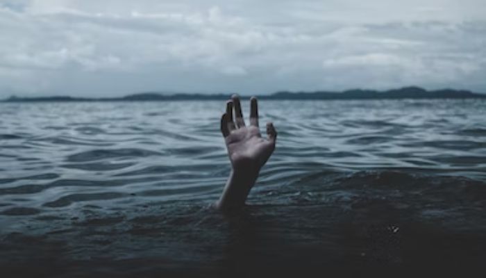 A hand appears from the ocean.— Unsplash