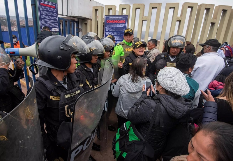 Peruvian police guard the entrance to Cusco airport after it was closed due to protests, stranding tourists in the Machu Picchu region.— AFP