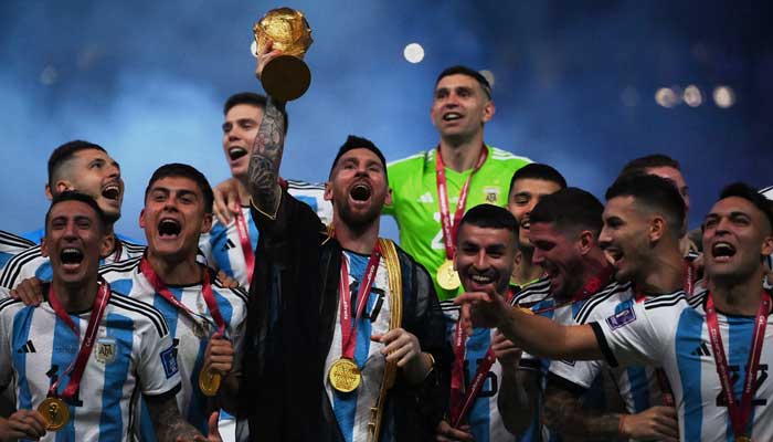 Argentinas forward #10 Lionel Messi lifts the World Cup trophy during the Qatar 2022 World Cup trophy ceremony after the football final match between Argentina and France at Lusail Stadium in Lusail, north of Doha on December 18, 2022. — AFP