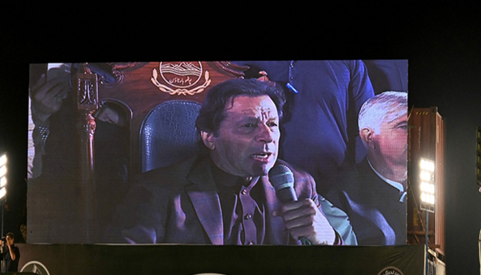 Former prime minister Imran Khan appears on a giant screen as he addresses an anti-government rally in Rawalpindi on November 26, 2022. — AFP