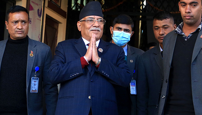 Daha çok Prachanda lakabıyla tanınan Nepal'in eski gerilla lideri Pushpa Kamal Dahal (2L), Katmandu'nun eteklerindeki Bhaktapur'da yeni başbakan olarak atanması için çoğunluğu talep etmek üzere cumhurbaşkanlığının ofisinden ayrılırken medya temsilcilerine jest yapıyor. 25 Aralık 2022. — AFP
