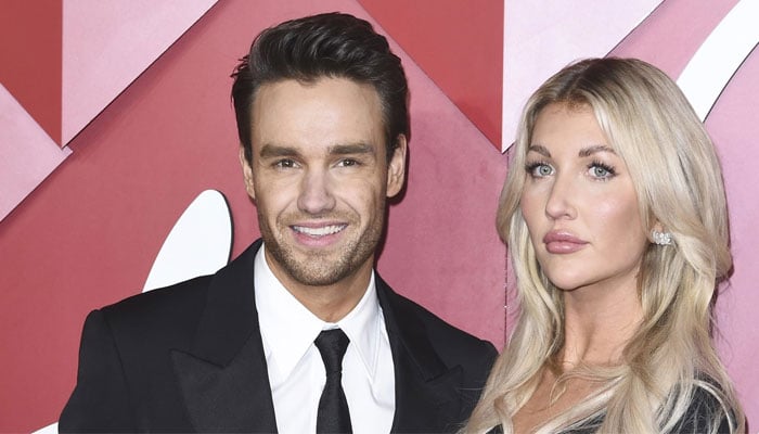 Liam Payne cosy up to girlfriend Kate Cassidy at a Christmas party