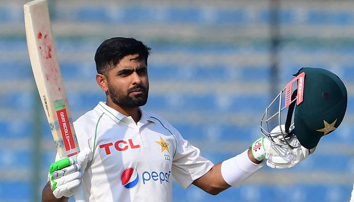 Pakistans captain Babar Azam gestures after scoring a century (100 runs) during the first day of the first cricket Test match between Pakistan and New Zealand at the National Stadium in Karachi on December 26, 2022.— AFP