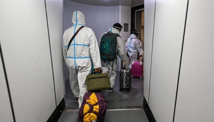 China said on December 26, 2022 that it would scrap mandatory quarantine on arrival, further unwinding years of strict virus controls as the country battles a surge in cases.— AFP