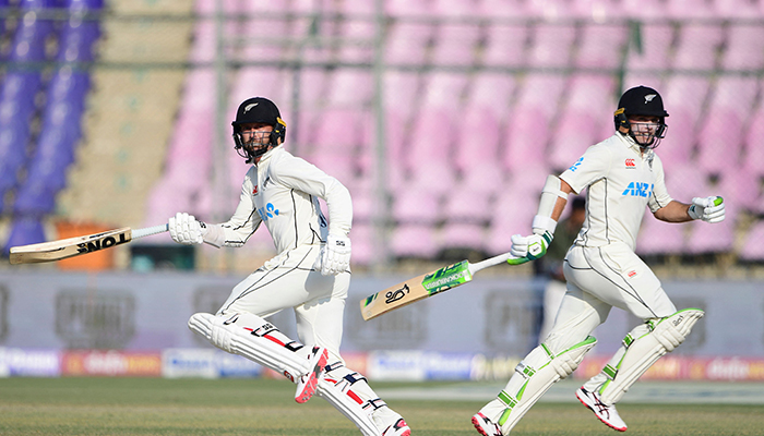 New Zealands Devon Conway (L) and Tom Latham run between the wickets during the second day of the first cricket Test match between Pakistan and New Zealand at the National Stadium in Karachi on December 27, 2022. — AFP