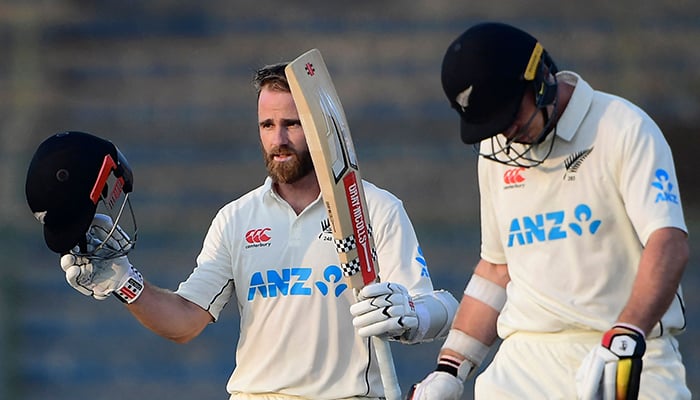 New Zealands Kane Williamson (left) celebrates after scoring a century (100 runs) as his teammate Michael Bracewell watches during the third day of the first Test match between Pakistan and New Zealand at the National stadium in Karachi on December 28, 2022. — AFP