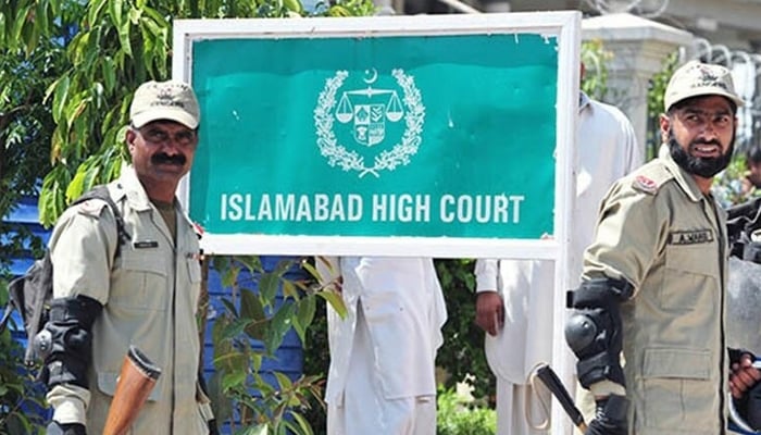 Security personnel stand guard outside the Islamabad High Court (IHC). — AFP/File