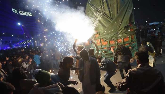 Citizens dance to music at Seaview amid celebrations. — AFP/File