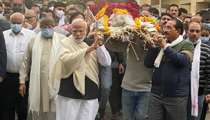 Indian Prime Minister Narendra Modi and others carry his mother on their shoulders to perform her last rites. — Twitter/@HardeepSPuri