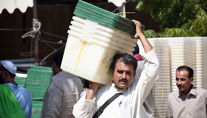 Polling agents collect electoral material ahead of a by-election in Karachi on October 15, 2022. — Online