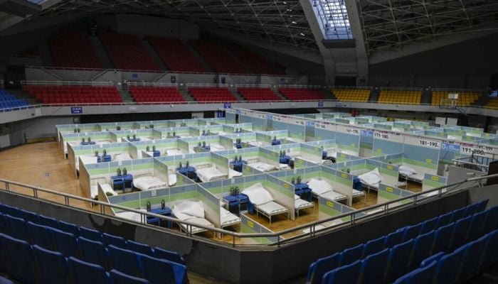 Patient beds in Beijing stadium. China could see over 1m Covid deaths in 2023.— AFP