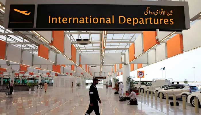 An airport staffer walks past the entrance of international departures at the Islamabad airport. — Reuters/File  Govt to outsource three major airports to international operators 1025479 8951181 isloo airport updates