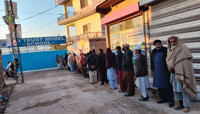 Voters waiting for polling stations to open while standing in a queue. — Twitter/@fawadchaudhry