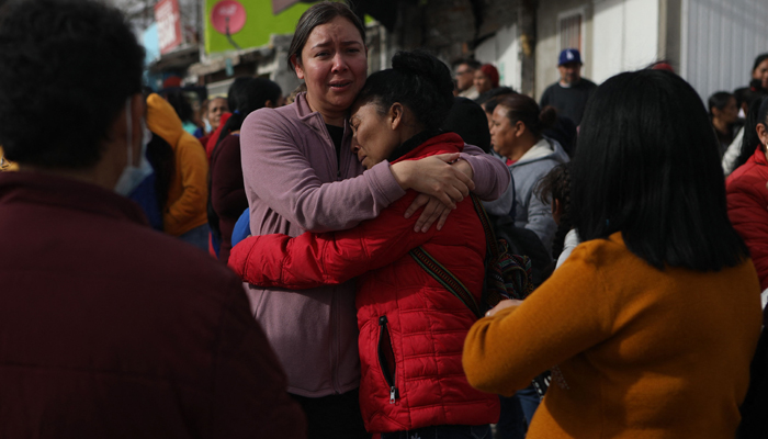 Relatives of inmates react outside the prison of Ciudad Juarez number 3 after the attack. — AFP