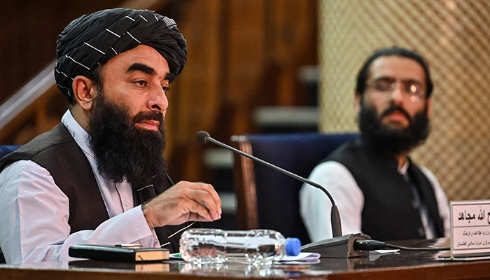 Taliban spokesman Zabiullah Mujahid (left) participates in a press conference at the government media and information center in Kabul, on November 10, 2021. — AFP