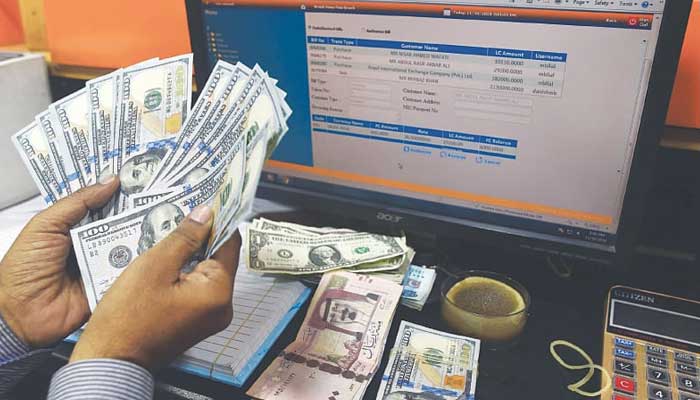 A person counting dollar bills. — AFP  SBP-held forex reserves plunge to $4.5 billion: sources 1028203 2866857 SBP updates