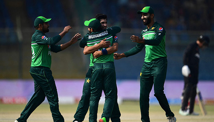Pakistan´s Naseem Shah (C back) celebrates with teammates after taking the wicket of New Zealand´s Devon Conway (not pictured) during the first one-day international (ODI) cricket match between Pakistan and New Zealand at the National Stadium in Karachi on January 9, 2023. — AFP
