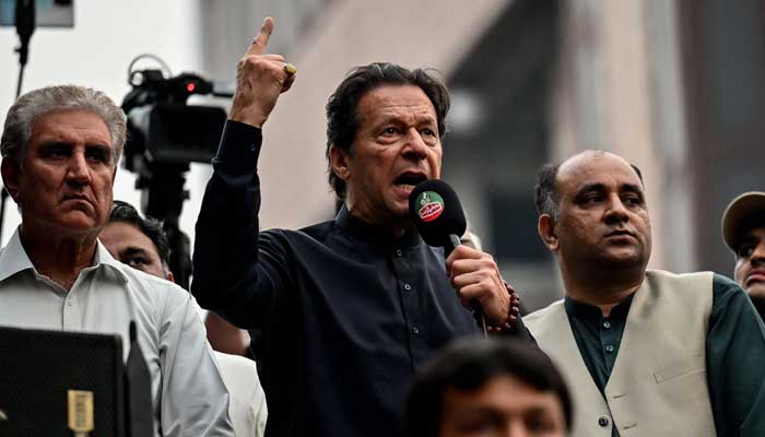 Former prime minister Imran Khan (centre) addresses his supporters during an anti-government march towards capital Islamabad, demanding early elections, in Gujranwala on November 1, 2022. — AFP