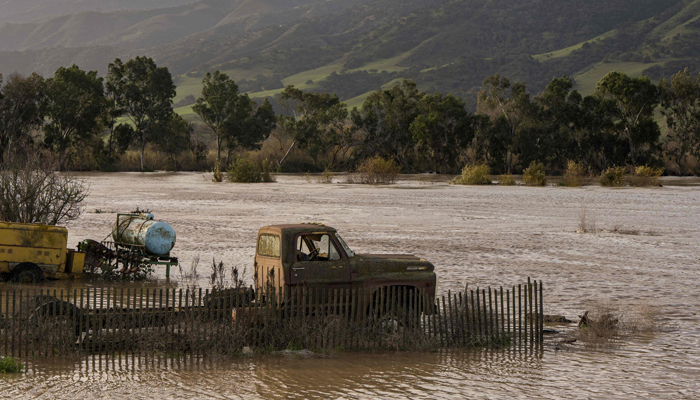 A truck is submerged in floodwaters from Salinas River near Chualar, California, on January 12. — AFP