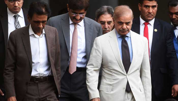 Prime Minister Shehbaz Sharif, MQM-P leader Khalid Maqbool Siddiqui and Amir Khan with Sindh Chief Minister Syed Murad Ali Shah leave after a meeting in Karachi on April 13, 2022. — AFP