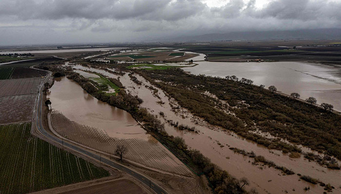 In this aerial picture taken on January 14, 2023, the Salines River overflows its banks, inundating farms near Chualar, California. — AFP