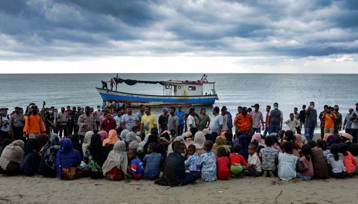 In this file photograph taken on June 25, 2020, evacuated Rohingya from Myanmar sit on the shorelines of Lancok village, in Indonesia´s North Aceh Regency, after some 100 including 30 children were rescued from a wooden boat off the coast of Indonesian island of Sumatra. — AFP