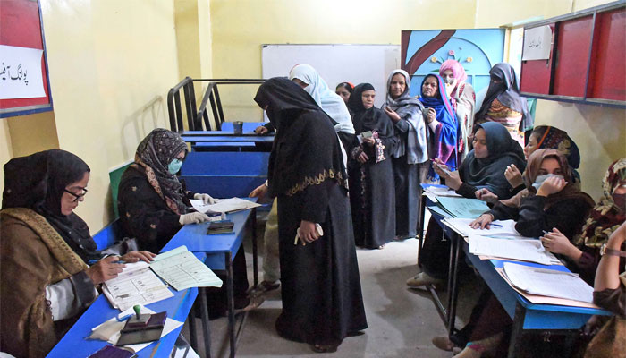Women voters stand in a queue in a polling station to cast their ballots during local government elections, in Provincial Capital. ONLINE PHOTO by Sabir Mazhar