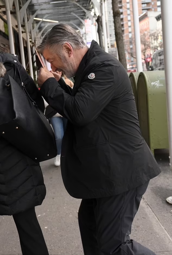 Alec Baldwin covers his face in public in first appearance since manslaughter charge