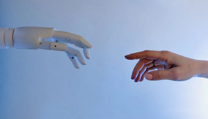 Person Reaching Out to a Robot.— Pexels