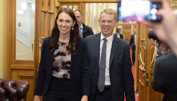 New Zealand Prime Minister Jacinda Ardern (L) and Chris Hipkins arrive at the Labour caucus meeting to elect a new premier at Parliament in Wellington on January 22, 2023. — AFP