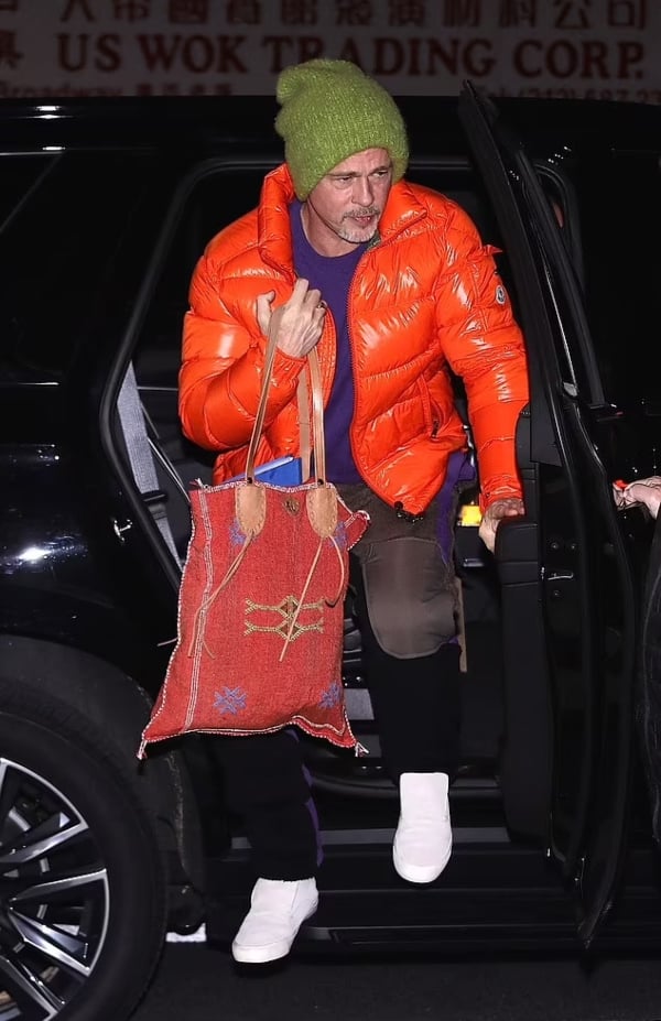 Brad Pitt steps out in bright orange coat alongside George Clooney in NYC
