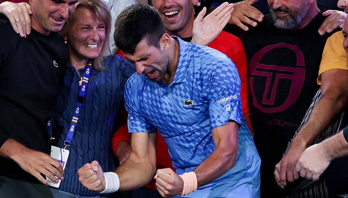 Serbias Novak Djokovic (C) celebrates victory against Greeces Stefanos Tsitsipas during their mens singles final on day fourteen of the Australian Open tennis tournament in Melbourne on January 29, 2023. — AFP