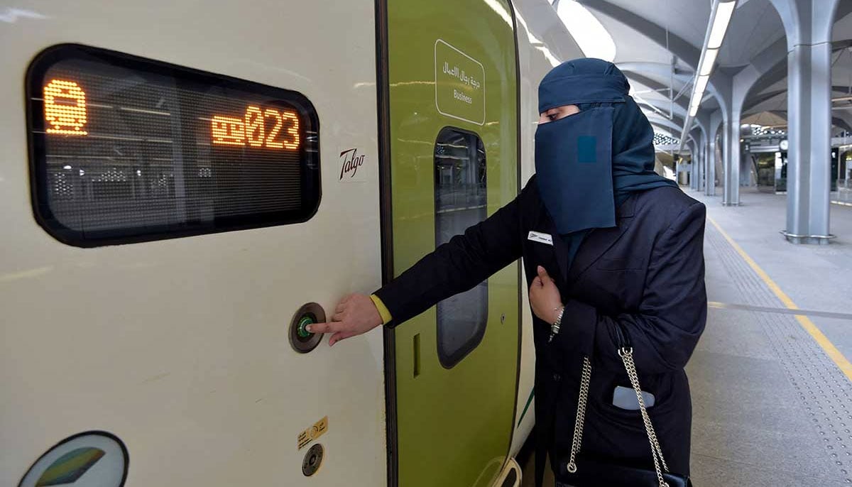 Tharaa Ali opens the door of the high-speed train. — AFP