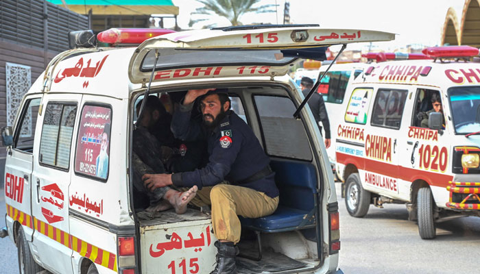 An ambulance transports injured blast victims outside the police headquarters in Peshawar on January 30, 2023. — AFP