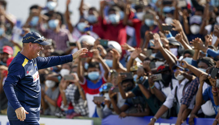 Mickey Arthur waves to fans at the end of the second Test cricket match between Sri Lanka and West Indies at the Galle International Cricket Stadium in Galle on December 3, 2021. — AFP