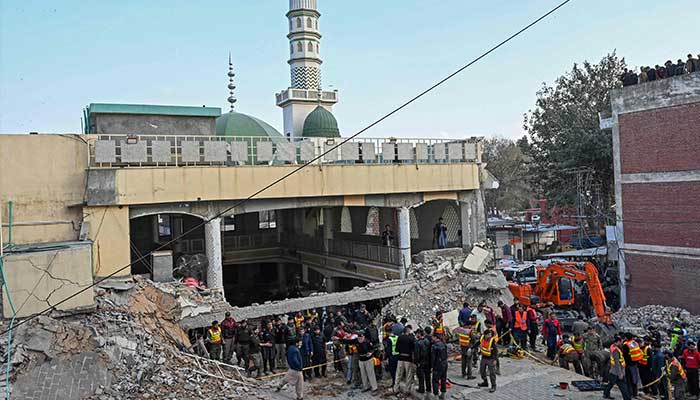 Security personnel and rescue workers prepare to search for the blast victims in the debris of a damaged mosque inside the police headquarters in Peshawar on January 30, 2023. — AFP