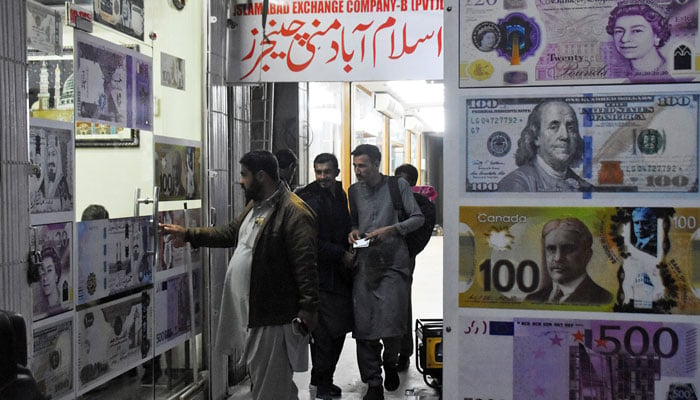 People enter a money changer shop in the blue area in Islamabad on January 26, 2023. — Online,