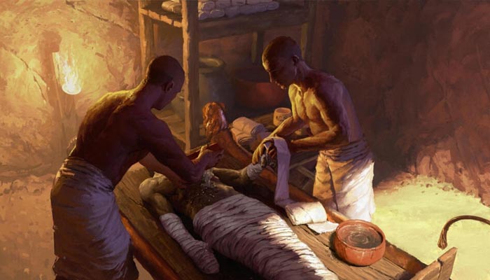 An artwork showing ancient Egyptians embalmers during the mummification process. — AFP/File