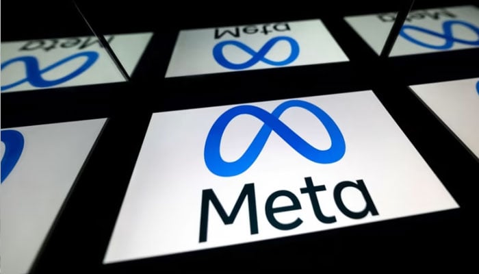Meta logo is seen on lighted screens reflected in a mirror. — AFP/File
