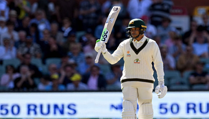 Australian batsman Usman Khawaja acknowledges the applause after scoring his fifty during the first day of the second cricket Test match between Australia and the West Indies at the Adelaide Oval. — AFP/File
