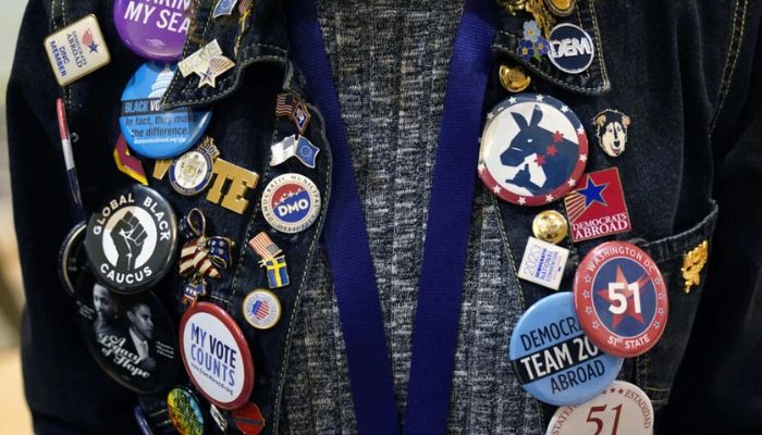 A Democratic activist shows off his pins at the Democratic National Committees winter convention in the US city of Philadelphia on February 3, 2023.— AFP