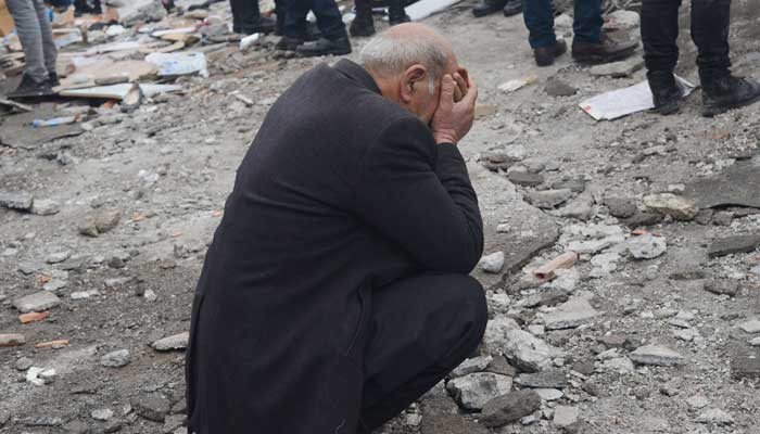 A man reacts as people search for survivors through the rubble in Diyarbakir, on February 6, 2023, after a 7.8-magnitude earthquake struck the country´s south-east. — AFP
