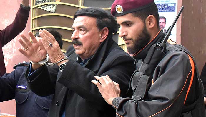Police escort AML chief Sheikh Rasheed Ahmed into an Islamabad court, after his arrest. — INP/File