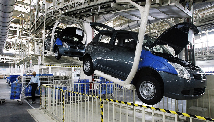 Suzuki Swift cars roll off the assembly line at an auto plant. — AFP/File