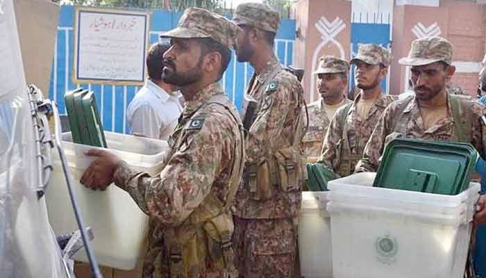 In this undated photo, the Pak Army soldiers seen carrying ballot boxes. Geo News/File