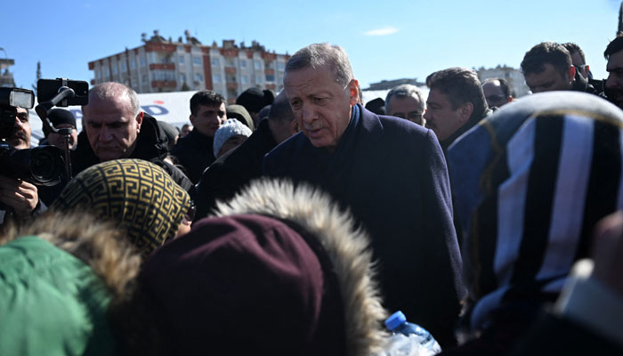 Turkish President Recep Tayyip Erdogan meets with residents who found refuge under tents set up by the government during his visit to the southeastern Turkish city of Kahramanmaras, two days after a strong earthquake struck the region, on February 8, 2023. —AFP