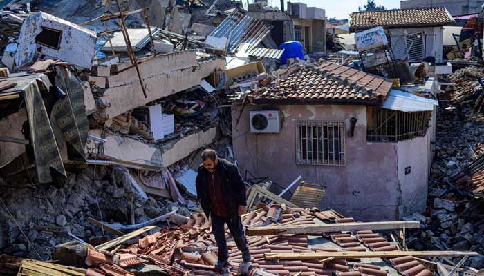 A local resident inspects the rubbles of destroyed buildings in Hatay, on February 11, 2023, after a 7.8-magnitude earthquake struck the country´s southeast. — AFP