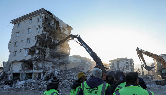 Aid workers demolish a heavily damaged building in Islahiye near Gaziantep on February 14, 2023, a week after a deadly earthquake struck parts of Turkey and Syria.—AFP